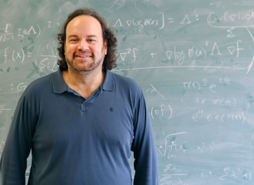 Jeffrey Rosenthal in front of chalkboard